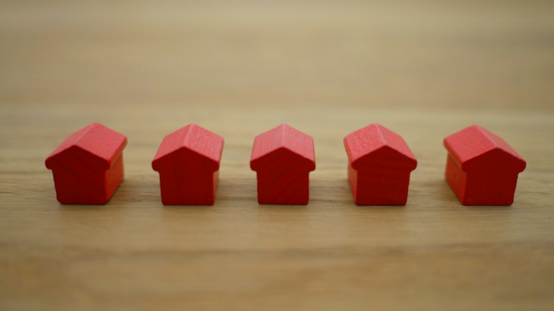 House keys held in front of a new home